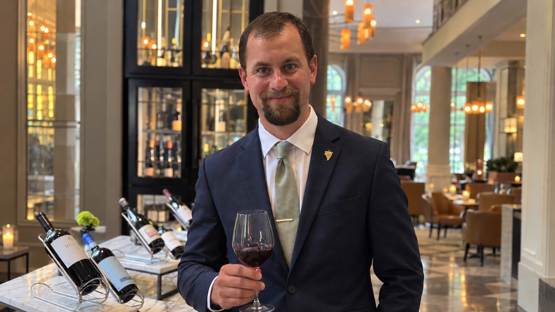 Portrait supplied for Julien Moreau, holding a wineglass in a restaurant